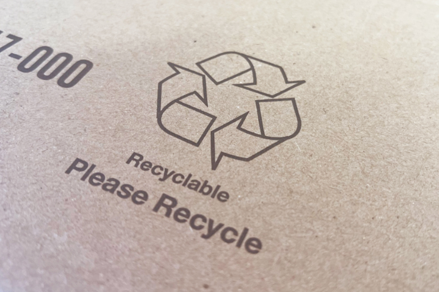 Cardboard with Recle Symbol and "Recyclable" and "Please Recycle" printed on the cardboard