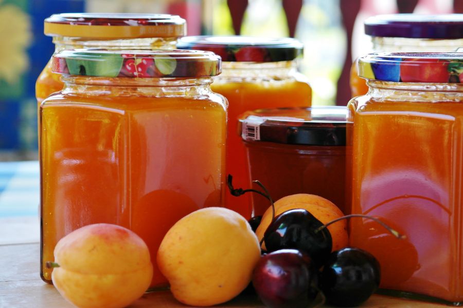 Fruit preserves and jams packaged in various glass jars