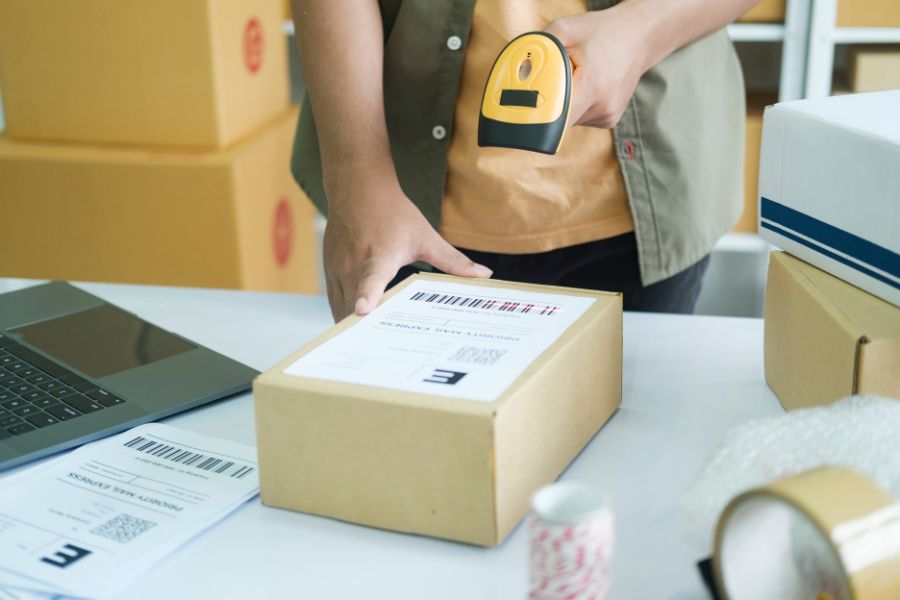 scanning cardboard box with product inside to be shipped