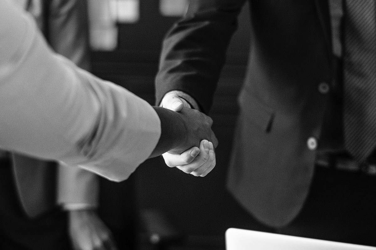 Black and white image of a business handshake