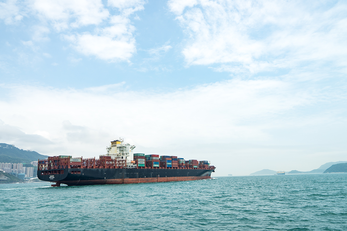 Image of ocean cargo ship with containers on the water