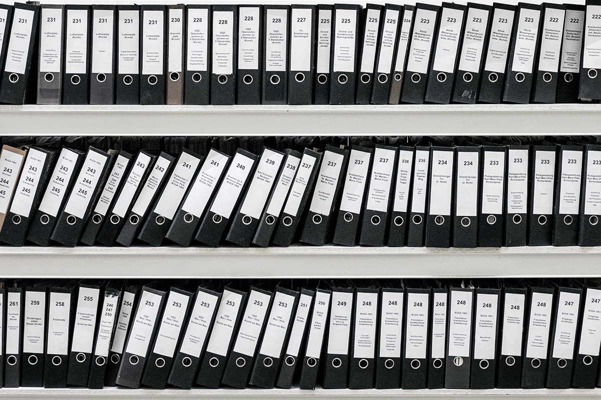 Image of bookshelf filled with binders of paperwork