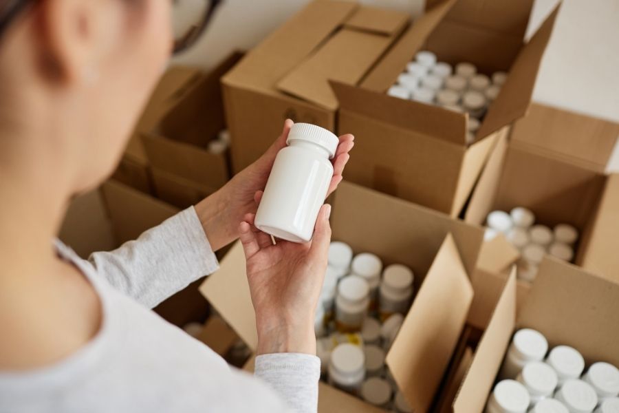 person unpacking packer bottles