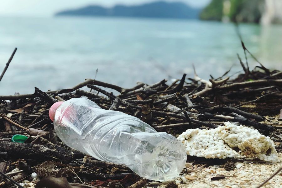 ocean bound plastic beverage bottle on the shore