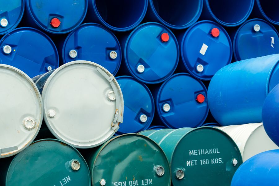 Plastic and metal drum containers stacked on their side