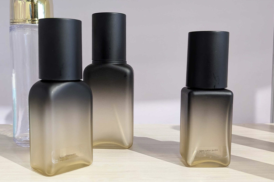 Glass bottles with gradient design as seen at Cosmoprof 2025