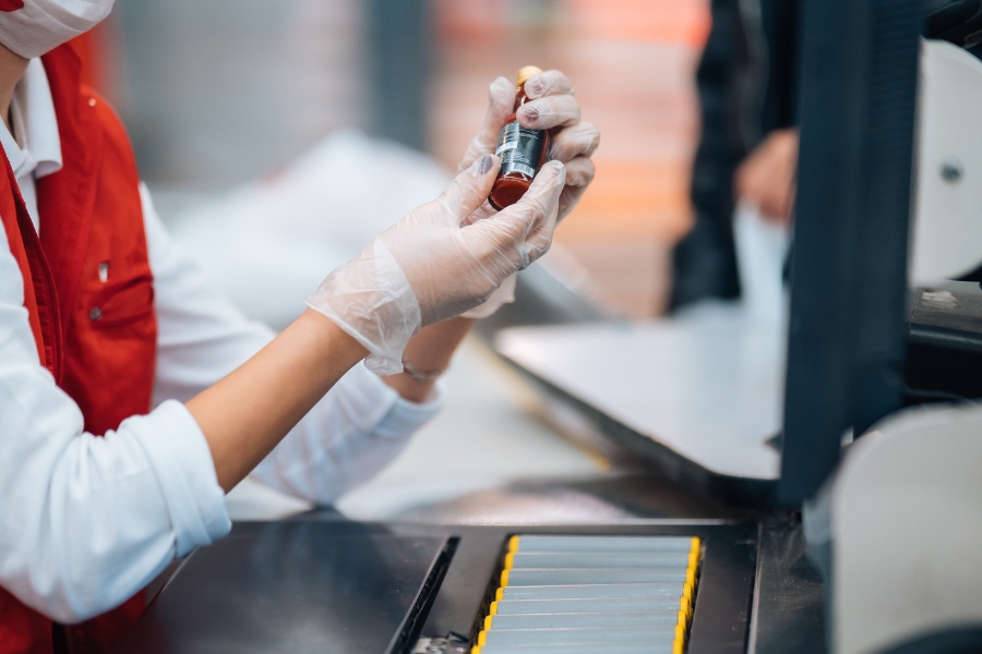 QC operator inspects packaging label for consistency