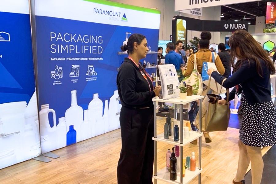 Female PG team member assists a visitor at our booth